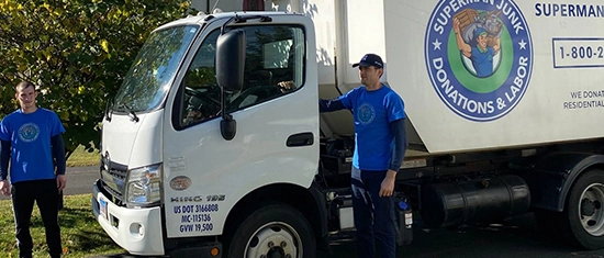 Junk removal company truck with team member ready for service.